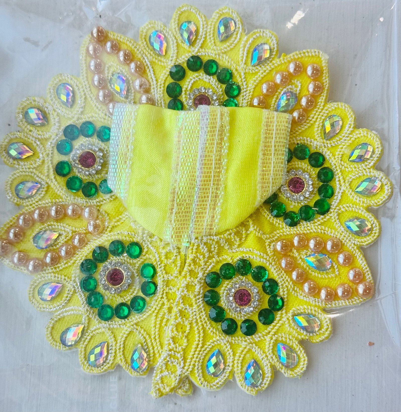 Yellow Laddu Gopal dress with green stones, mirror work, and golden pearl embellishments