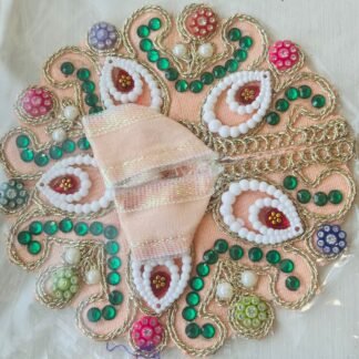 Peach Laddu Gopal dress adorned with white bead paisleys, green stones, and multicolor decorative beads