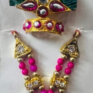 Laddu Gopal accessory set with a vibrant green fan-style mukut, pink and white kundan stones, and a pink-beaded necklace.
