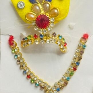 Laddu Gopal mala and mukut set with red center stones, golden pearl drops, multicolor beads, and blue-yellow feather backdrop