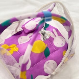 This adorable mosquito net bed for Laddu Gopal features a vibrant purple cushion with cute bunny and fruit prints. Designed to keep your deity safe from insects while adding a touch of charm to the mandir, the set includes a soft padded base, built-in pillow, and a delicate white mesh canopy supported by a colorful printed frame. Ideal for Laddu Gopal idols in sizes 0 to 3.