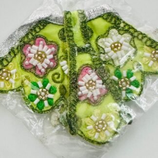 Lime green Radha Rani dress with multicolor floral bead embroidery and silver lace border, sealed in a transparent plastic cover