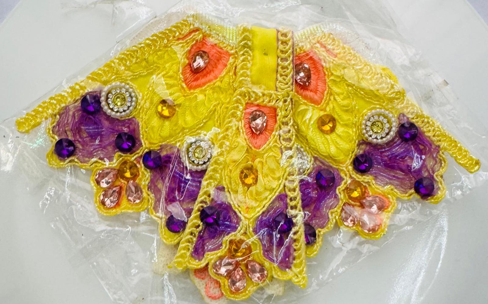 Yellow and purple Radha Rani dress with colorful embroidery and jewel embellishments