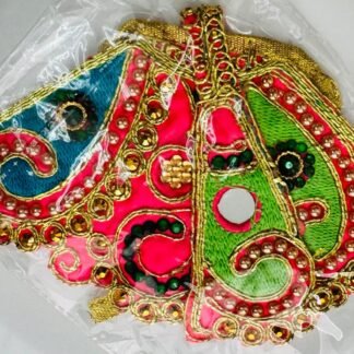 A colorful Radha Rani dress featuring vibrant pink, green, and blue sections, adorned with pearls, gold sequins, and intricate embroidery.