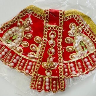 Red Radha Rani dress with golden embroidery, pearl detailing, and rich fabric