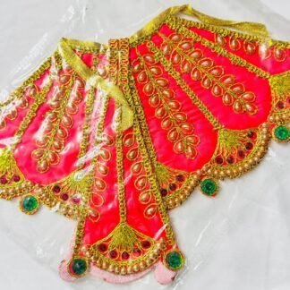 Peach Radha Rani dress with golden embroidery, pearls, and green gemstone accents