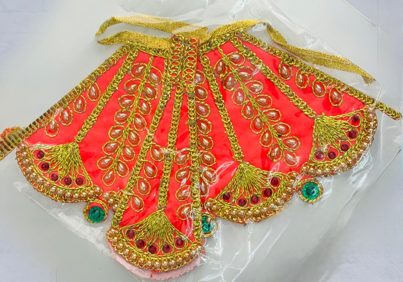 Red Radha Rani Lehenga with golden embroidery, kundan stones, and pearl border detailing